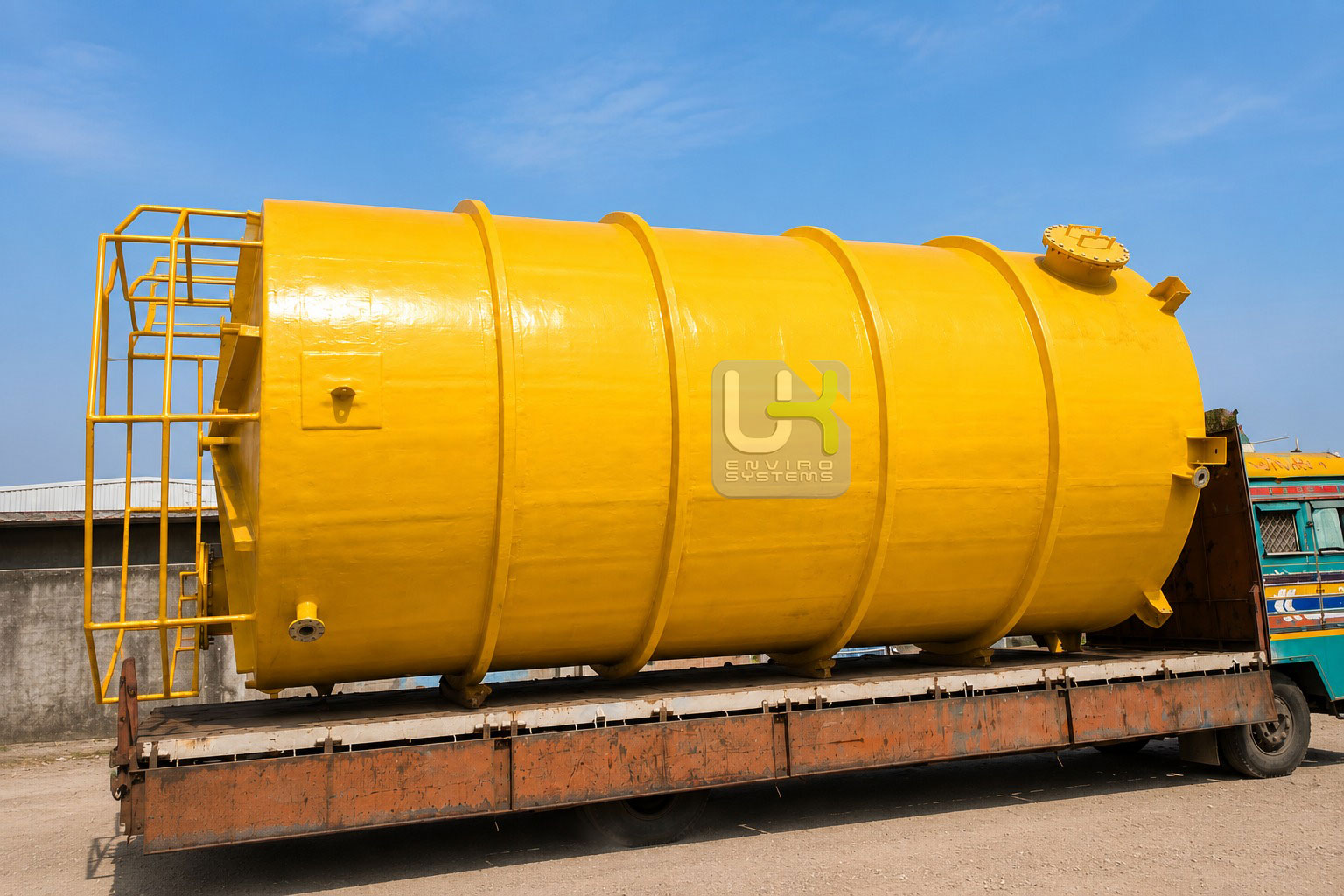 200 KL FRP acid storage tank being crane-lifted onto trailer